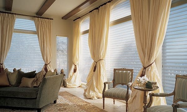 Silhouette window shadings with drapes in a living room