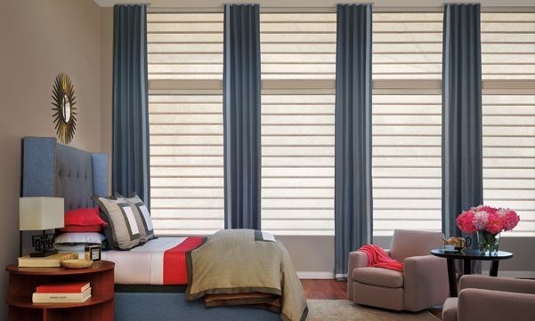 Vignette roman shades with drapes in a bedroom