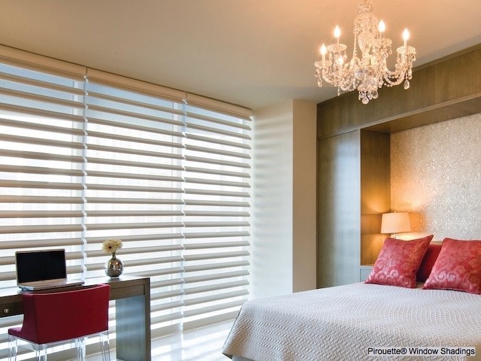 A bedroom with a chandelier.